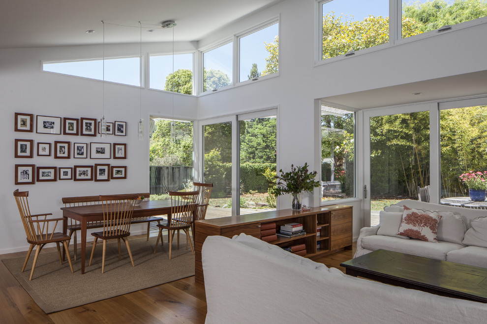 Contemporary dining room in San Francisco with white walls and medium hardwood floors.