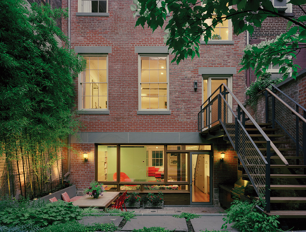 Design ideas for a transitional brick red exterior in New York.