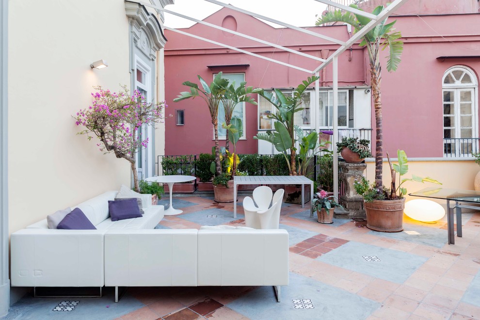 Inspiration for an expansive contemporary side yard deck in Naples with a container garden and a pergola.