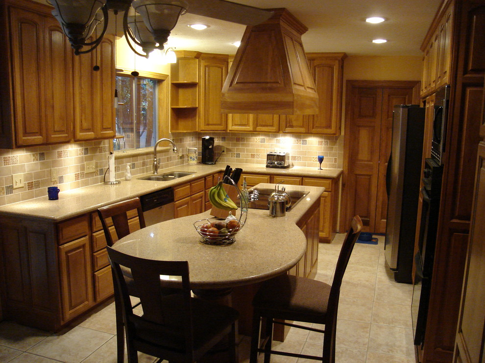Example of a mid-sized transitional l-shaped ceramic tile eat-in kitchen design in Houston with a double-bowl sink, raised-panel cabinets, light wood cabinets, solid surface countertops, multicolored backsplash, subway tile backsplash, stainless steel appliances and an island