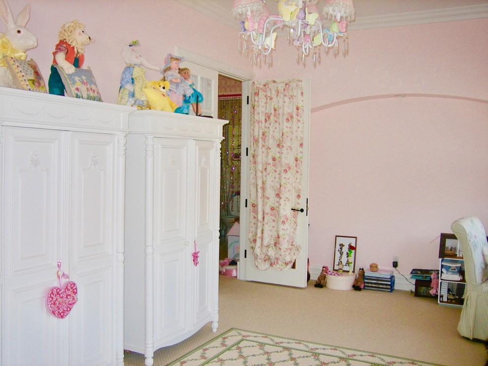 Design ideas for a mid-sized traditional kids' playroom for kids 4-10 years old and girls in Los Angeles with pink walls and pink floor.