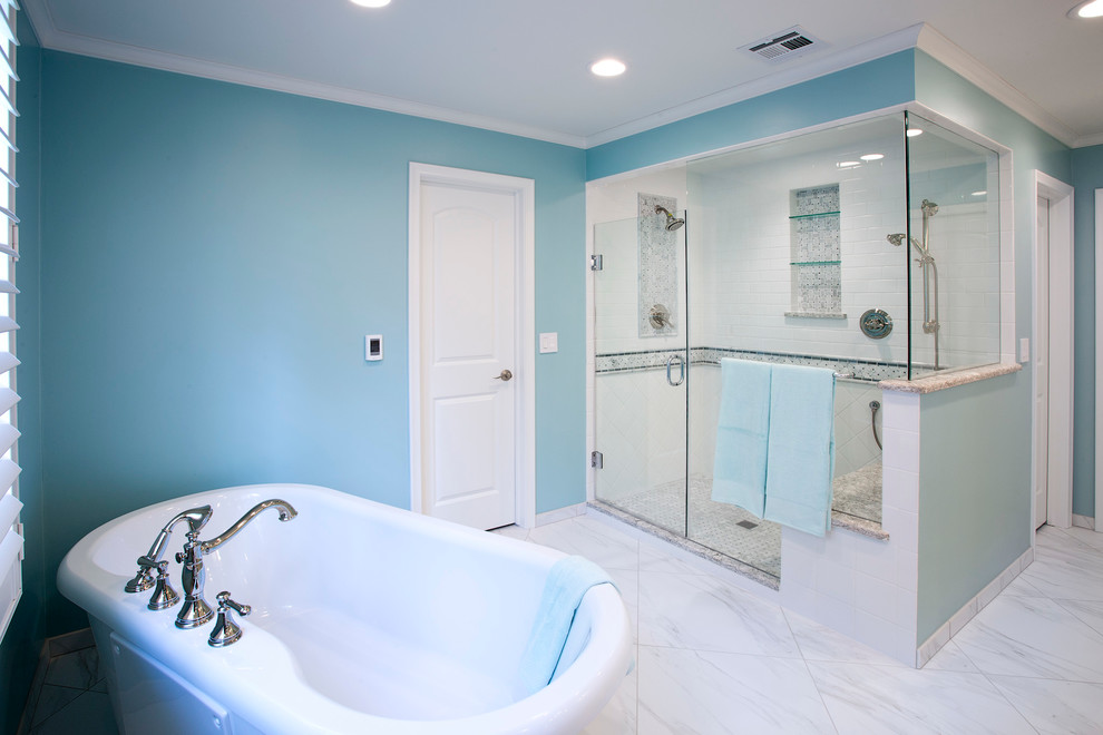 Design ideas for a large traditional master bathroom in Wichita with recessed-panel cabinets, white cabinets, a freestanding tub, white tile, stone tile, blue walls, porcelain floors, an undermount sink, engineered quartz benchtops and a corner shower.