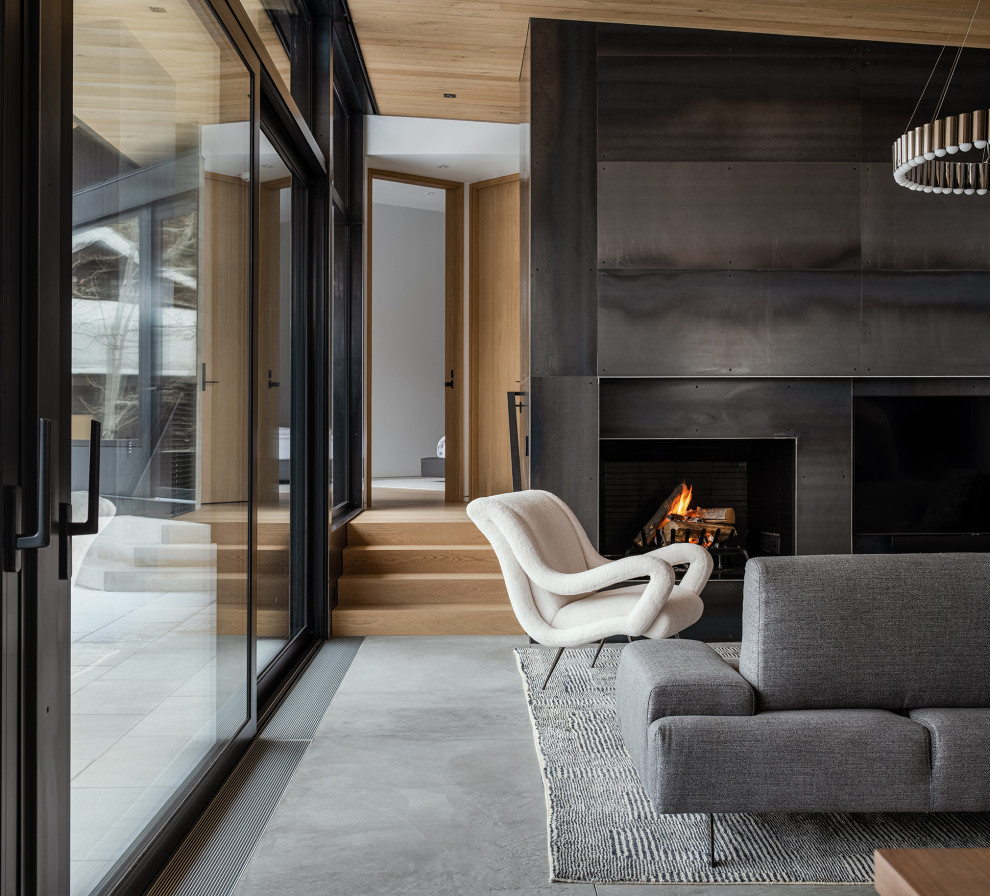 Mid-sized mountain style open concept concrete floor, wood ceiling and wood wall living room photo in Other with a standard fireplace and a metal fireplace