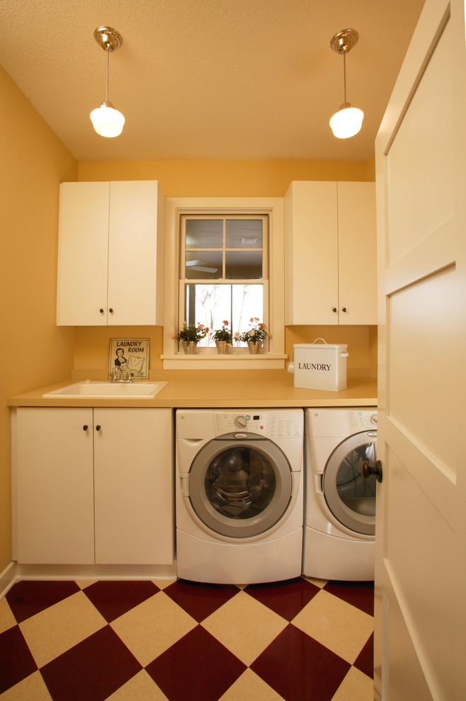 Design ideas for a traditional laundry room in Minneapolis with white cabinets.