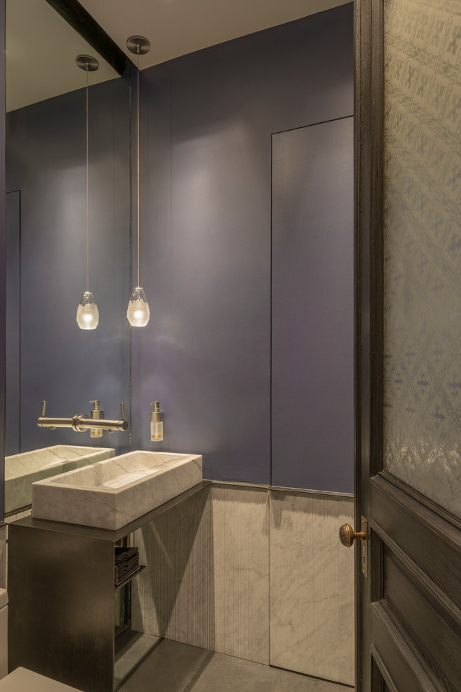 Mid-sized minimalist 3/4 white tile and stone tile concrete floor bathroom photo in New York with open cabinets, gray cabinets, a one-piece toilet, purple walls, a vessel sink and marble countertops
