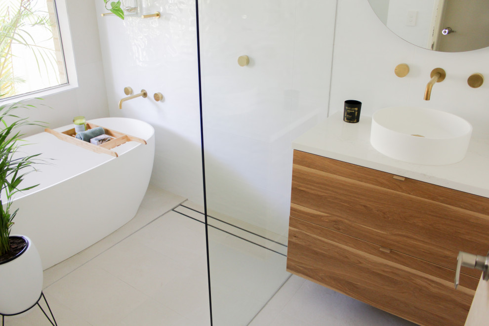 Photo of a mid-sized modern kids wet room bathroom in Perth with flat-panel cabinets, dark wood cabinets, a freestanding tub, white tile, porcelain tile, white walls, porcelain floors, a vessel sink, engineered quartz benchtops, grey floor, an open shower, white benchtops, a single vanity and a floating vanity.