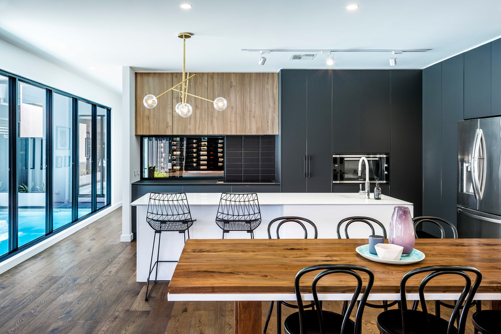 Contemporary kitchen in Adelaide with black cabinets, black splashback and with island.