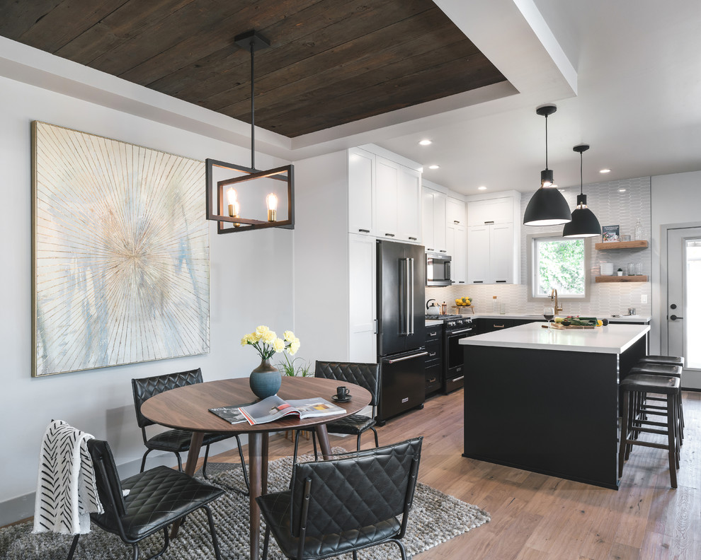 Photo of a mid-sized transitional kitchen/dining combo in Portland with grey walls, medium hardwood floors and brown floor.