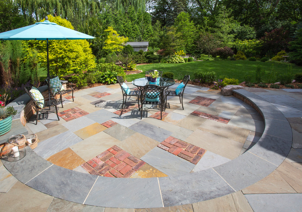 Inspiration for a small transitional backyard patio in Other with natural stone pavers and no cover.