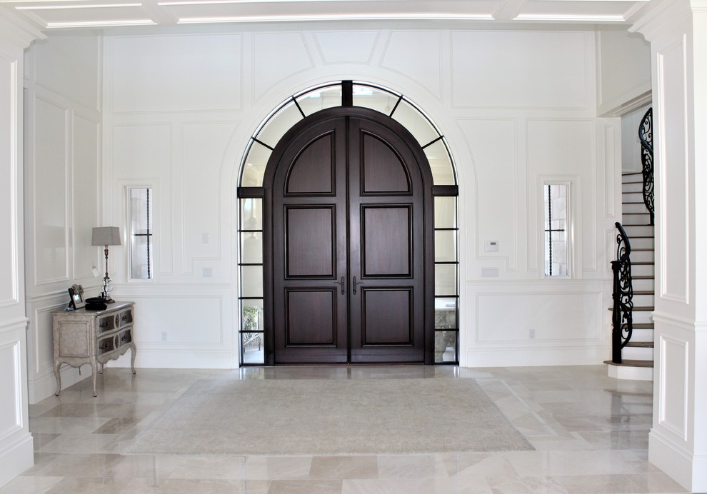 Inspiration for a mid-sized transitional porcelain tile and beige floor front door remodel in Miami with white walls and a dark wood front door