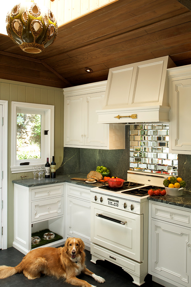 Design ideas for an eclectic kitchen in Los Angeles with white appliances and mirror splashback.