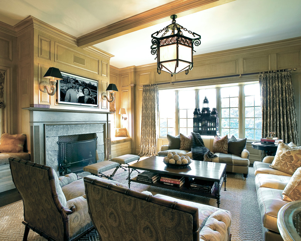 Inspiration for a large traditional open concept family room in New York with beige walls, dark hardwood floors, a standard fireplace, a stone fireplace surround and a wall-mounted tv.
