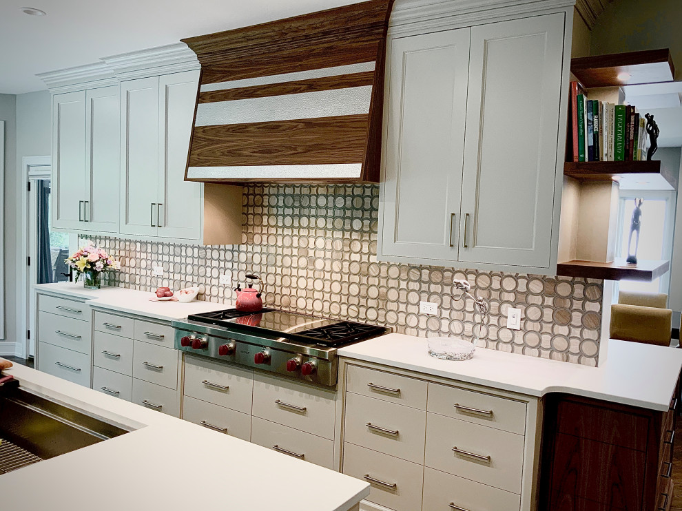 Eat-in kitchen - huge transitional l-shaped medium tone wood floor and brown floor eat-in kitchen idea in Chicago with an undermount sink, flat-panel cabinets, white cabinets, quartzite countertops, beige backsplash, glass tile backsplash, stainless steel appliances, an island and white countertops