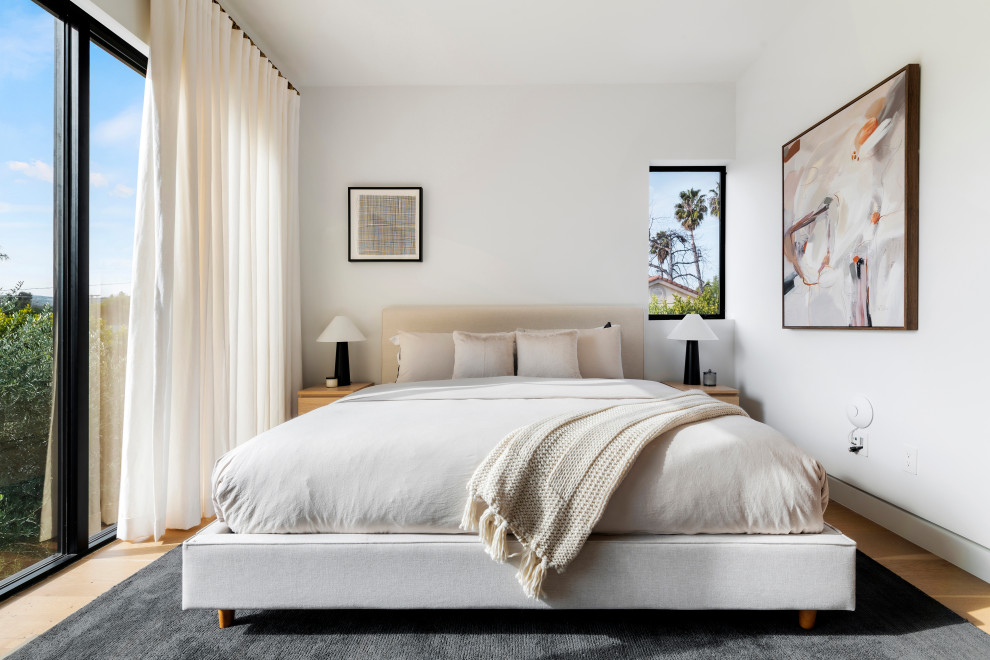 Mid-sized trendy guest beige floor and light wood floor bedroom photo in Los Angeles with white walls and no fireplace