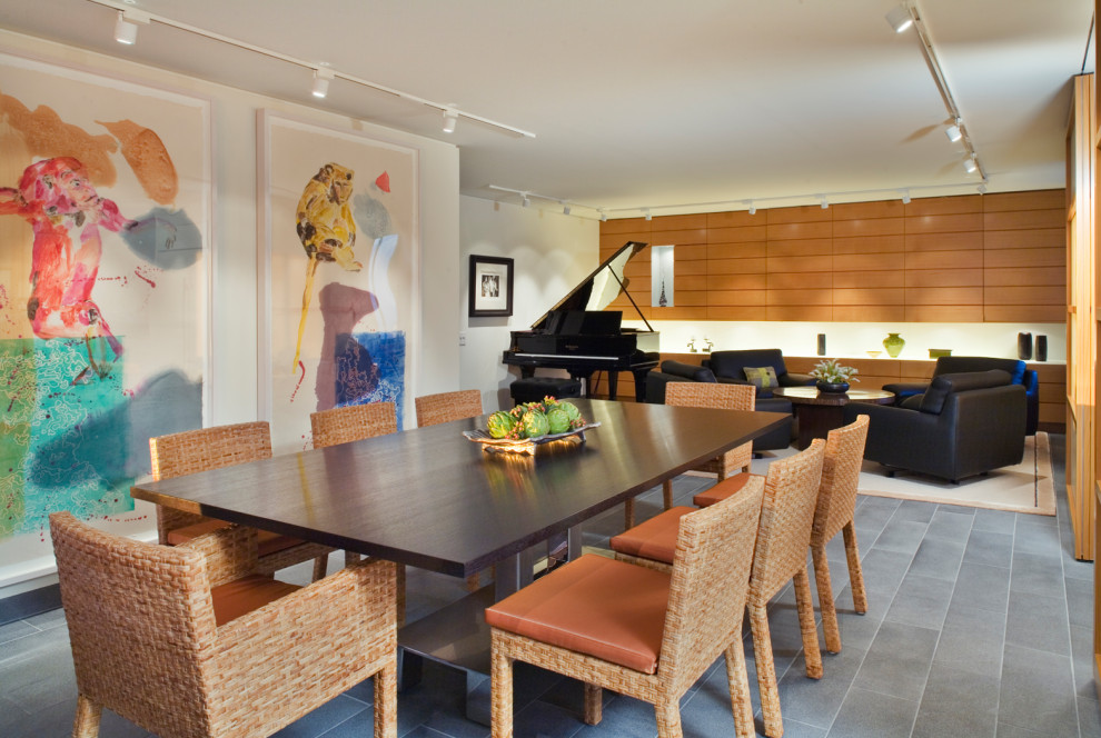 This is an example of a mid-sized asian open plan dining in New York with white walls, slate floors, no fireplace, grey floor and panelled walls.