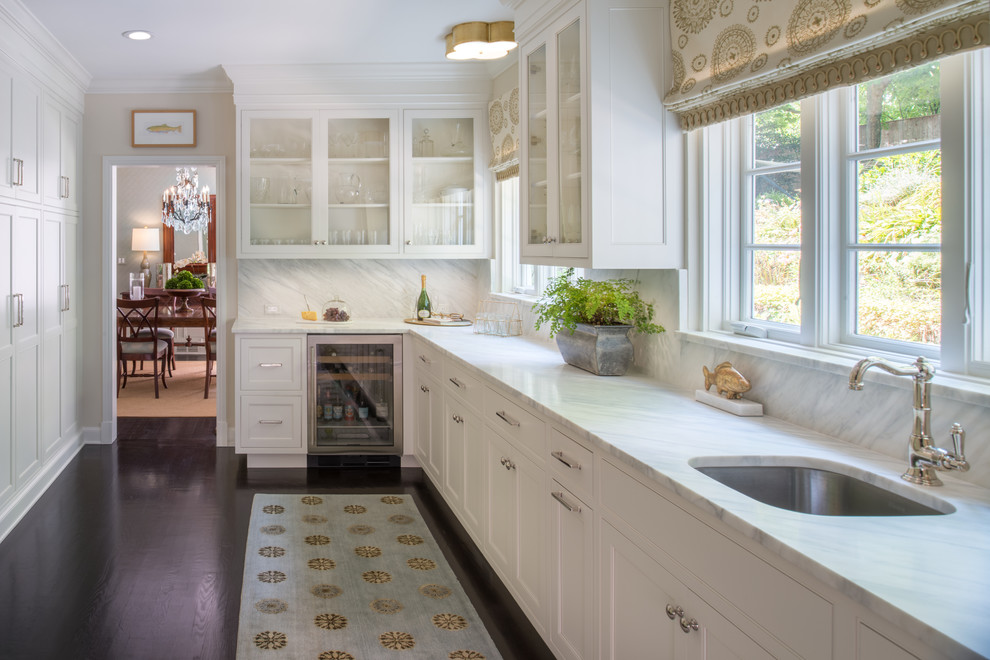 Photo of a mid-sized transitional galley kitchen pantry in DC Metro with an undermount sink, shaker cabinets, white cabinets, marble benchtops, multi-coloured splashback, marble splashback, stainless steel appliances, dark hardwood floors, no island and multi-coloured benchtop.