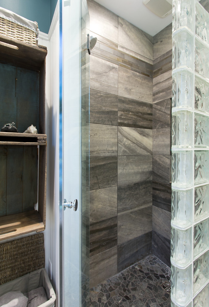Inspiration for a mid-sized beach style bathroom in Toronto with gray tile, porcelain tile, multi-coloured walls, porcelain floors, a pedestal sink, glass benchtops, a corner shower and a two-piece toilet.
