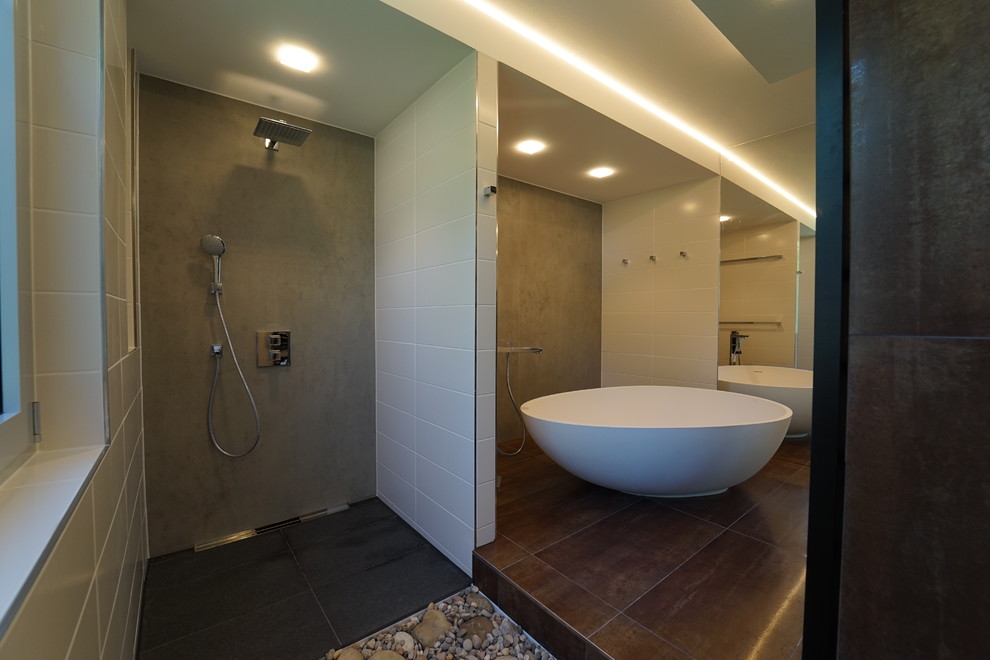 Photo of a contemporary bathroom in Frankfurt with a freestanding tub, a curbless shower and an open shower.
