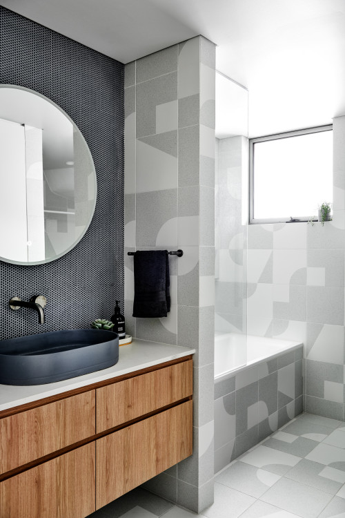 Geometric Bliss: Scandinavian Bathroom with Vessel Sink, Black Tile Backsplash, and Patterns