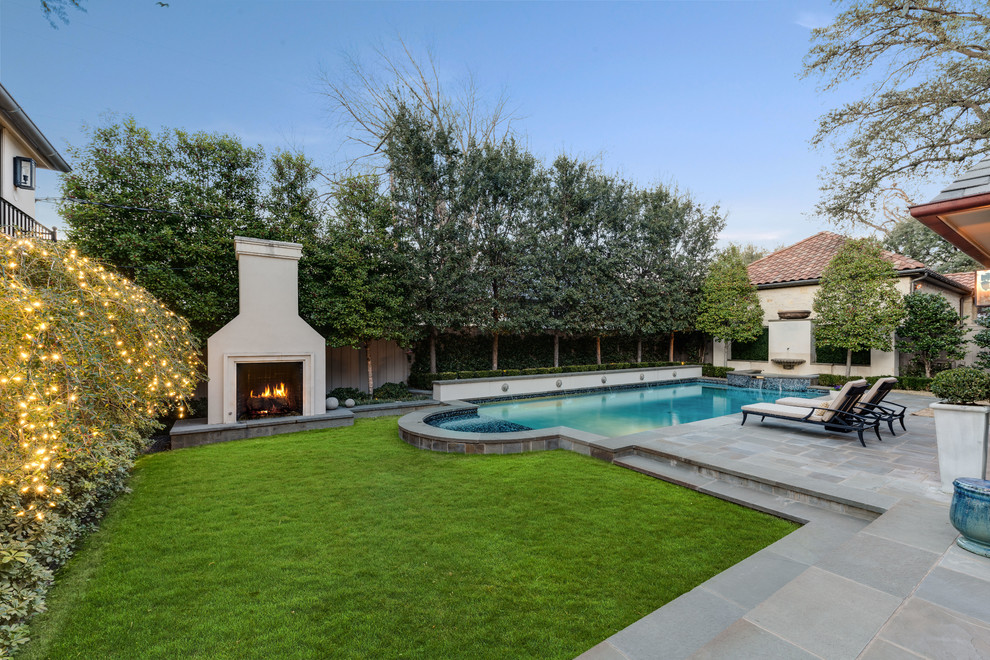 Photo of a transitional backyard rectangular lap pool in Dallas with a water feature and concrete pavers.