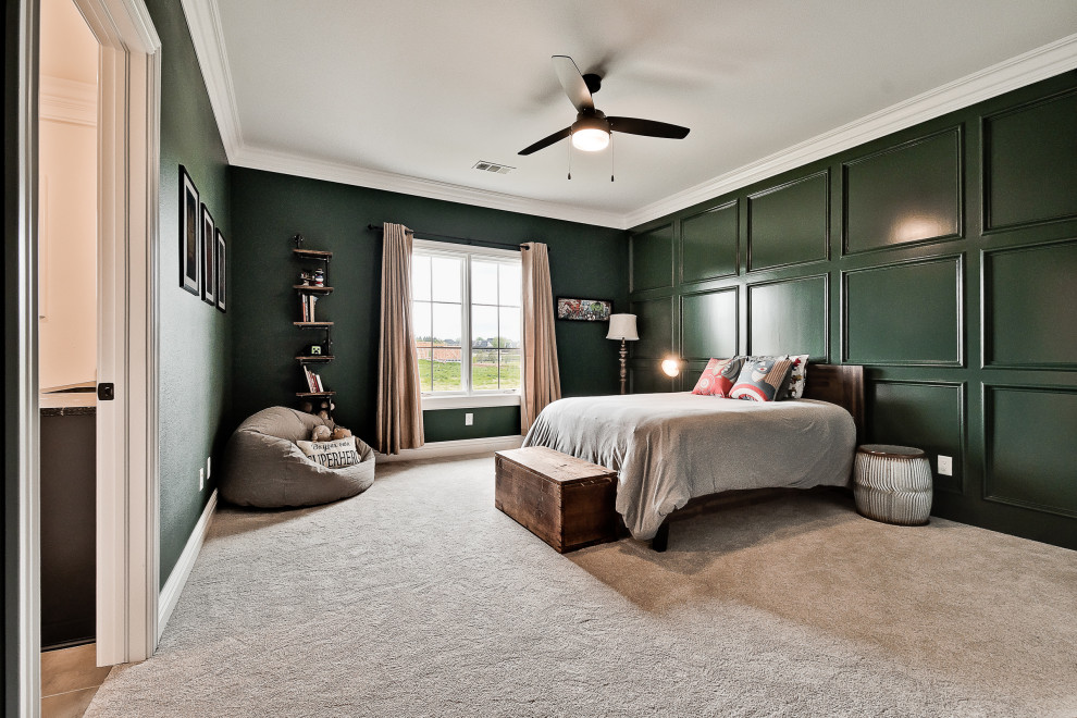 This is an example of a large classic guest bedroom in Other with green walls and carpet.