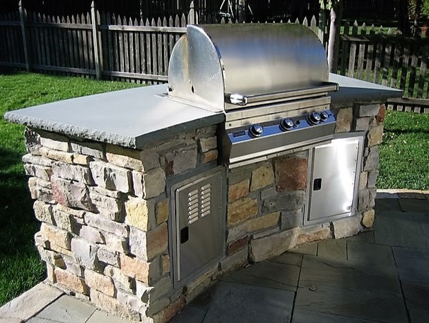 Inspiration for a mid-sized traditional backyard patio in Kansas City with an outdoor kitchen, stamped concrete and no cover.