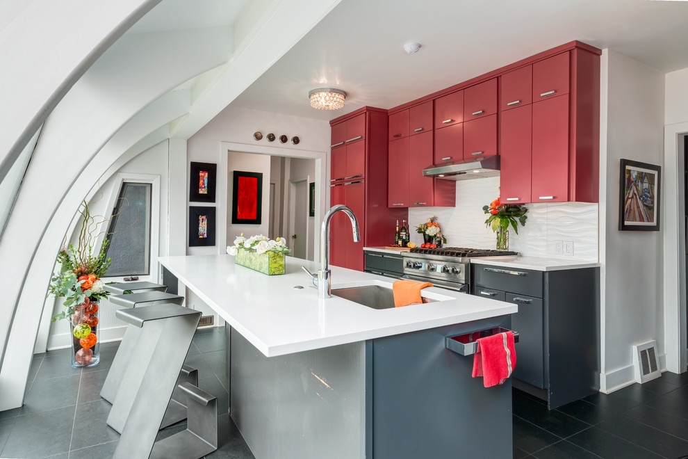 Inspiration for a contemporary galley kitchen in Calgary with an undermount sink, flat-panel cabinets, red cabinets, white splashback, stainless steel appliances, with island, quartzite benchtops, porcelain splashback and ceramic floors.