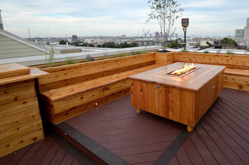 This is an example of a small arts and crafts rooftop deck in Baltimore with no cover, mixed railing and a fire feature.