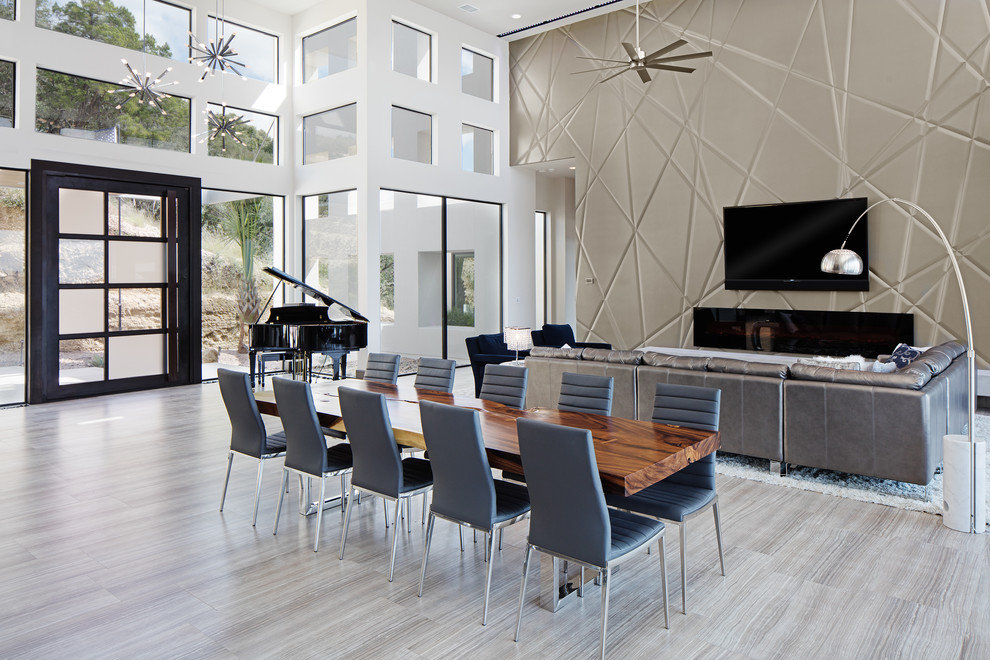 Large modern kitchen/dining combo in Austin with white walls, porcelain floors, a wood fireplace surround and a ribbon fireplace.