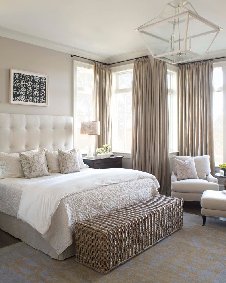 Beach style master bedroom in Charleston with beige walls, dark hardwood floors and brown floor.