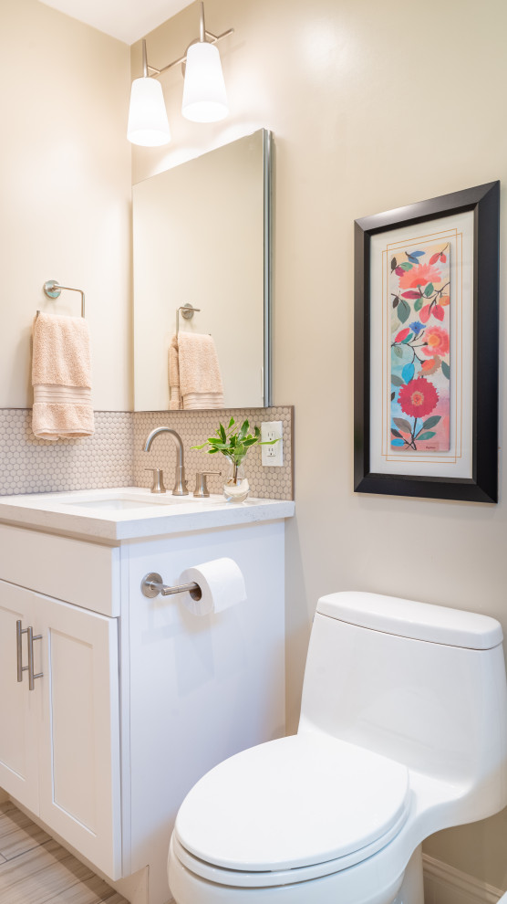 This is an example of a mid-sized contemporary bathroom in San Francisco with shaker cabinets, white cabinets, an alcove tub, a shower/bathtub combo, a one-piece toilet, beige tile, mosaic tile, white walls, porcelain floors, an undermount sink, engineered quartz benchtops, beige floor, a shower curtain, white benchtops, a shower seat, a single vanity and a built-in vanity.