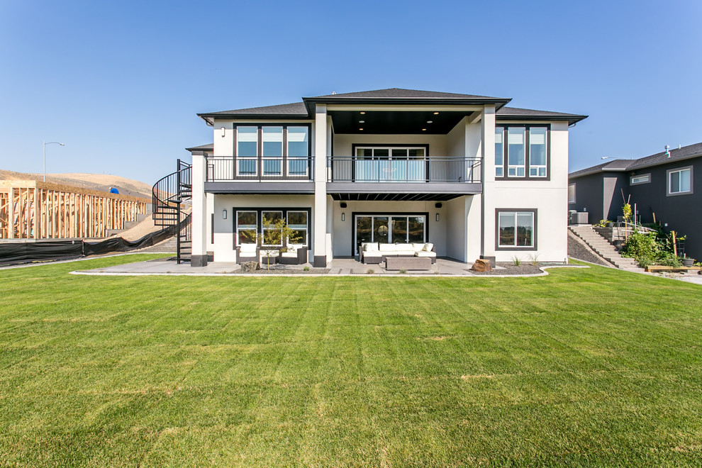 Example of a large trendy backyard deck design in Seattle with a roof extension