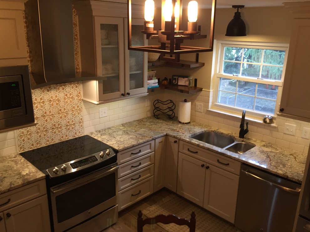 Mountain style brown floor kitchen photo in Cincinnati with a double-bowl sink, raised-panel cabinets, beige cabinets, granite countertops, white backsplash, terra-cotta backsplash and stainless steel appliances