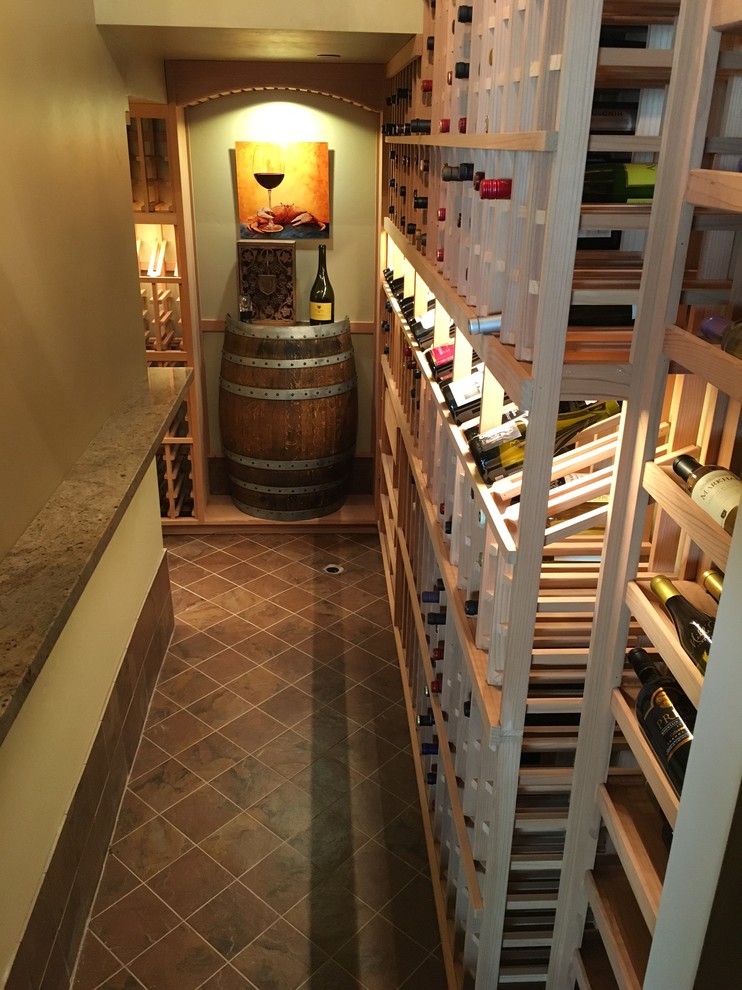 Inspiration for a mid-sized traditional wine cellar in San Diego with storage racks.
