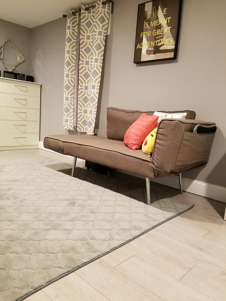 Inspiration for a mid-sized contemporary guest bedroom in Bridgeport with grey walls, laminate floors and no fireplace.