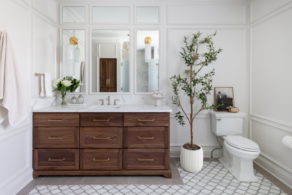 Inspiration for a timeless gray floor, single-sink and wall paneling bathroom remodel in Nashville with shaker cabinets, dark wood cabinets, white walls, an undermount sink, white countertops and a built-in vanity