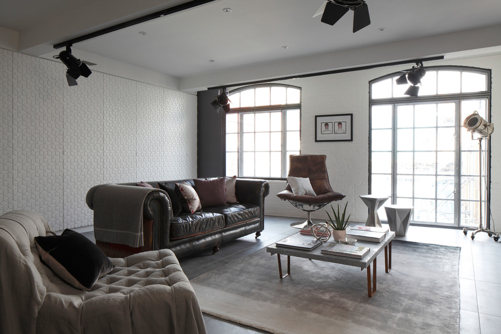 Inspiration for a mid-sized industrial open concept living room in London with concrete floors.