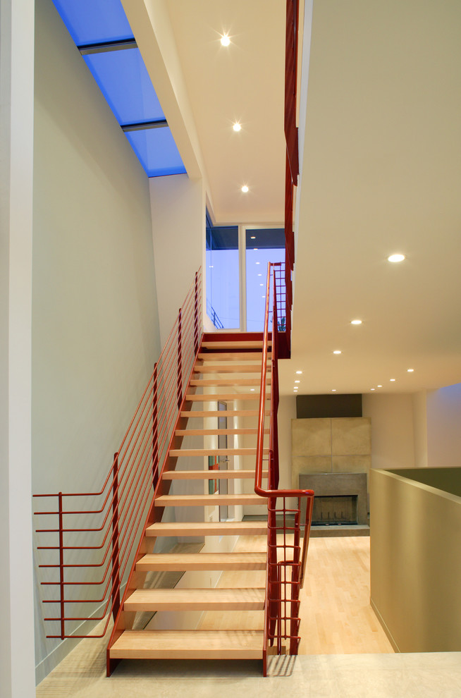 Photo of a contemporary wood floating staircase in Los Angeles with open risers.