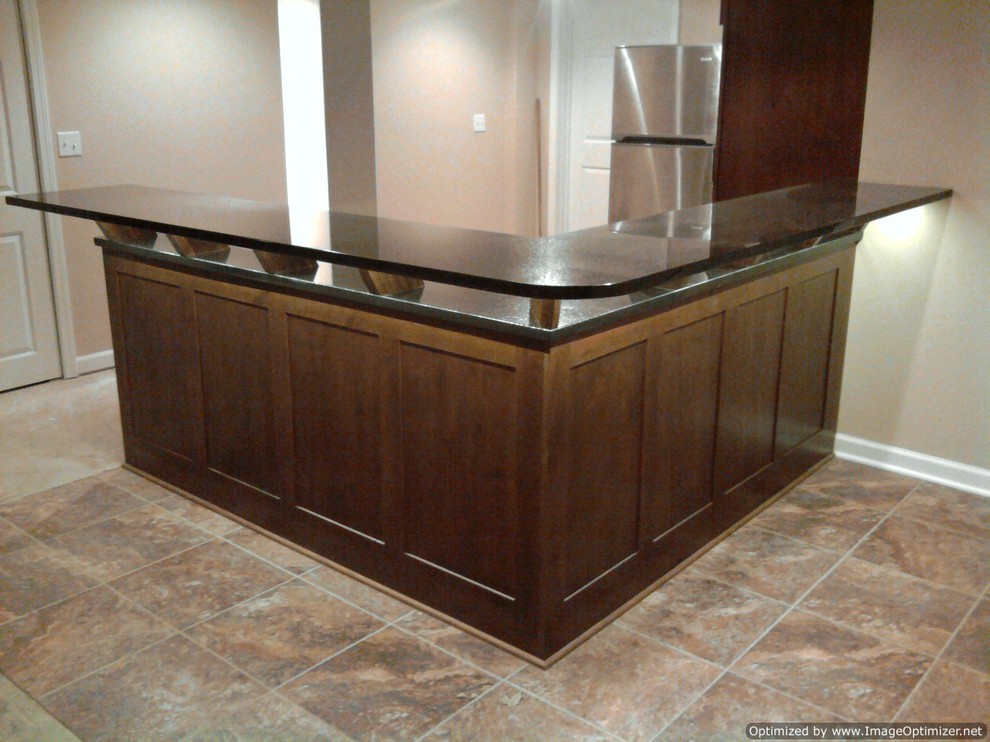 Example of a transitional u-shaped eat-in kitchen design in Chicago with an undermount sink, shaker cabinets, dark wood cabinets, granite countertops and stainless steel appliances