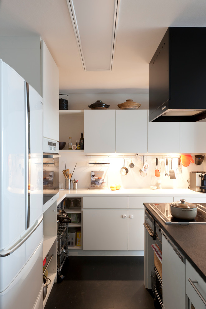 Mid-sized contemporary l-shaped eat-in kitchen in Tokyo with an undermount sink, flat-panel cabinets, white cabinets, terrazzo benchtops, white splashback, white appliances, dark hardwood floors and with island.