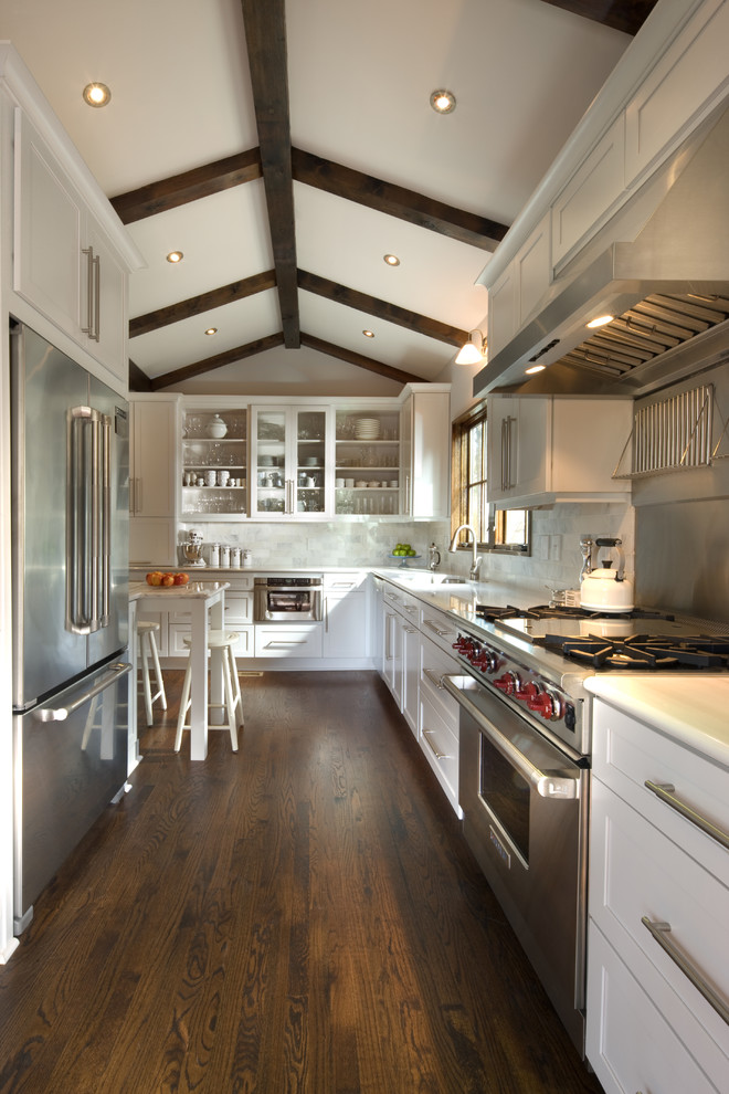 Inspiration for a transitional u-shaped eat-in kitchen in Atlanta with white cabinets, recessed-panel cabinets, stainless steel appliances and white splashback.