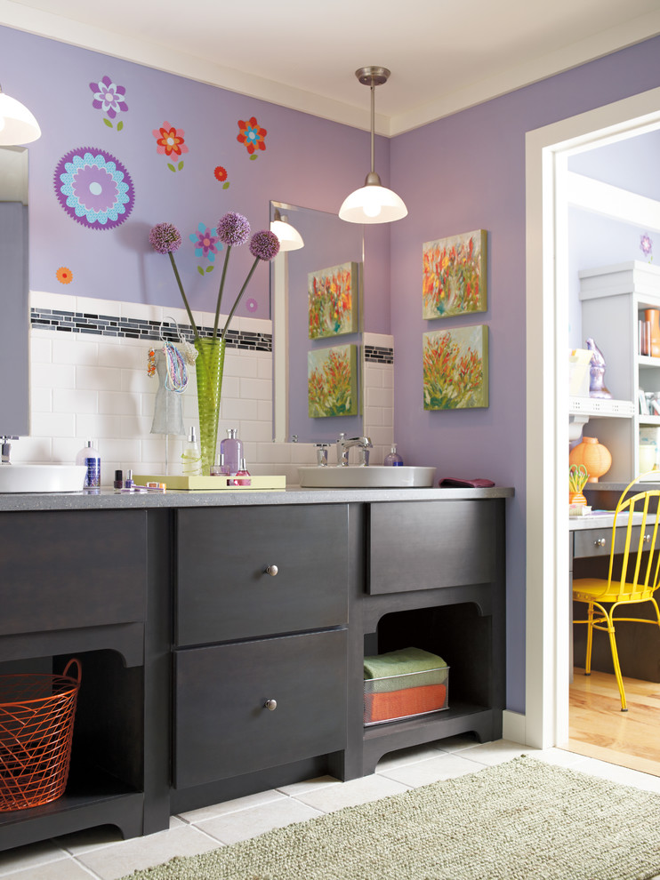 Photo of a mid-sized traditional kids bathroom in Other with dark wood cabinets, white tile, purple walls, flat-panel cabinets, subway tile, ceramic floors, a drop-in sink and limestone benchtops.