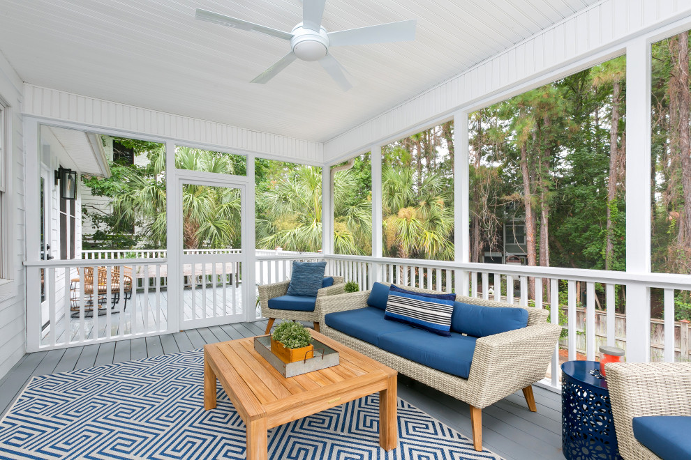 Mid-sized beach style backyard screened-in verandah in Charleston with a roof extension and decking.