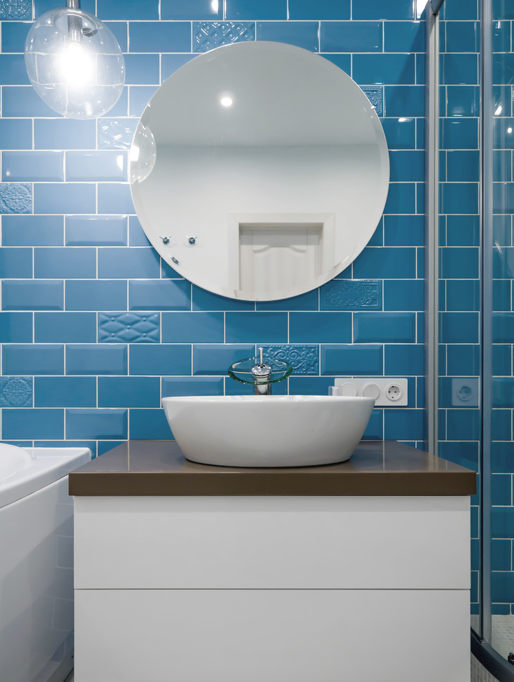 Inspiration for a mid-sized transitional 3/4 bathroom in Novosibirsk with flat-panel cabinets, white cabinets, a hot tub, a corner shower, a wall-mount toilet, blue tile, ceramic tile, blue walls, ceramic floors, a vessel sink, solid surface benchtops, white floor and a sliding shower screen.