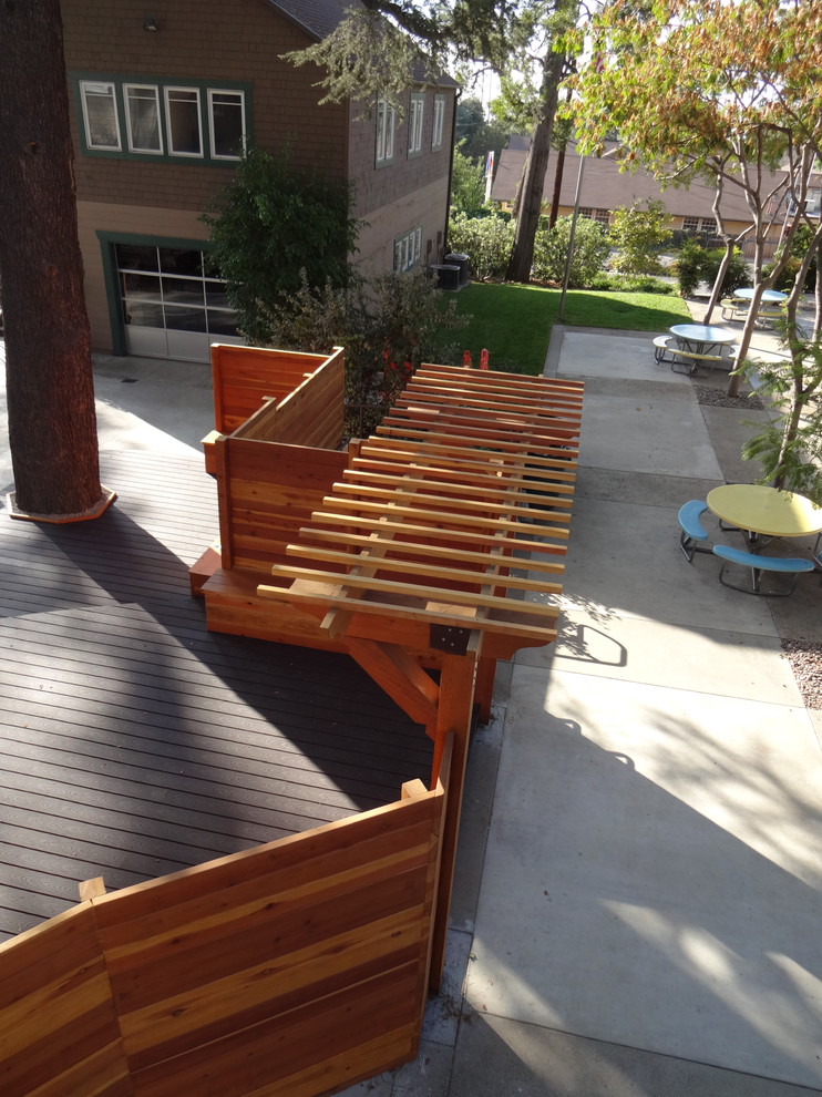 Design ideas for a large transitional side yard deck in Los Angeles with a pergola.