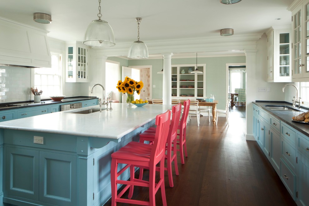 Beach style eat-in kitchen in Boston with an integrated sink, blue cabinets, marble benchtops, stainless steel appliances, dark hardwood floors, with island, brown floor and white benchtop.