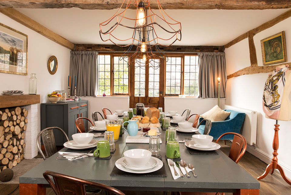 Inspiration for a country dining room in Other with dark hardwood floors and exposed beam.