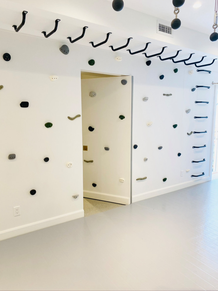 Minimalist perfection! - Example of a mid-sized cottage gender-neutral light wood floor, gray floor, wood ceiling and wall paneling playroom design in New York with white walls