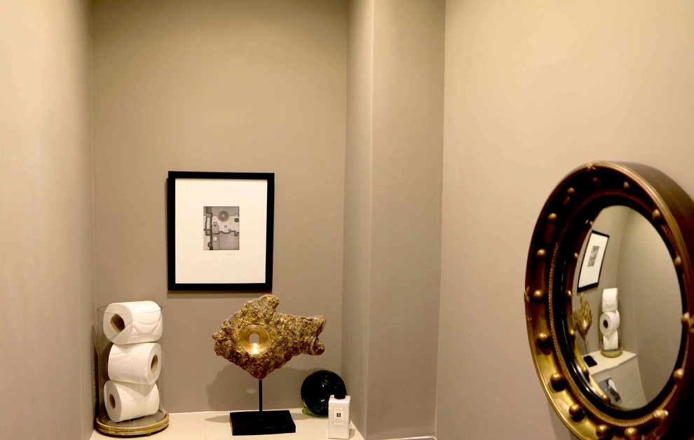 Inspiration for a small contemporary powder room remodel in London with gray walls