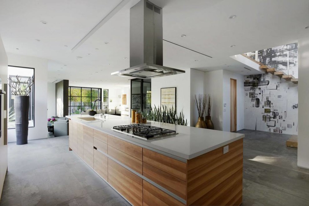 Large contemporary single-wall open plan kitchen in Other with flat-panel cabinets, medium wood cabinets, with island, an integrated sink and ceramic floors.